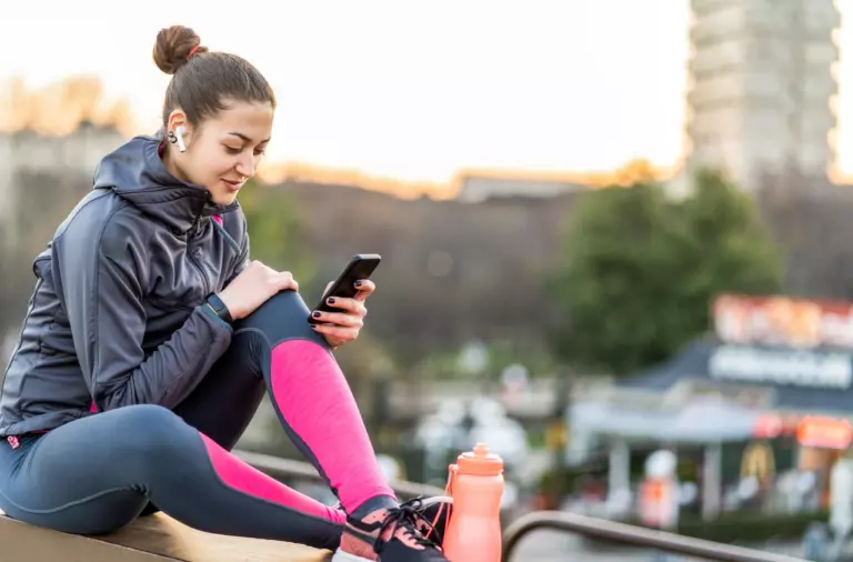 female looking at her biometric data on phone