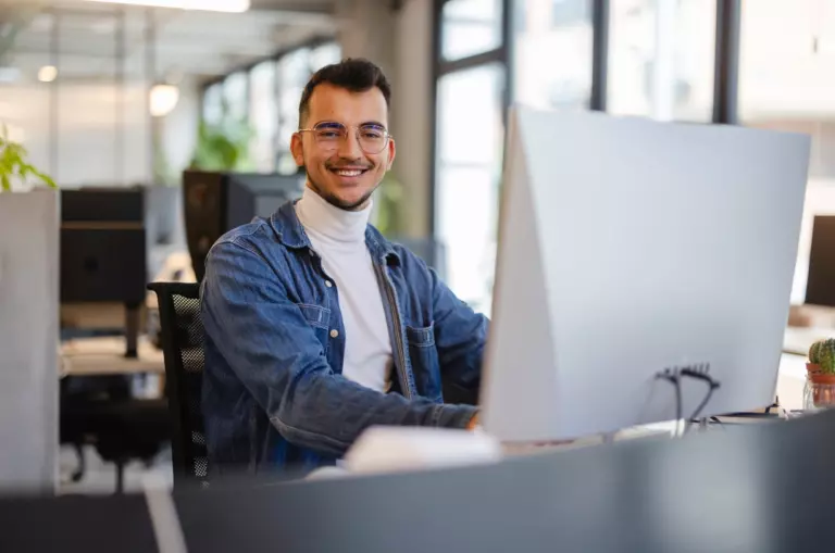 happy employee working at his desk