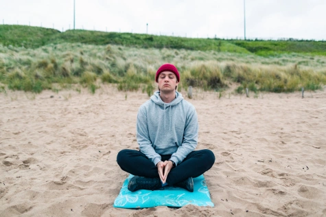 man meditating outside