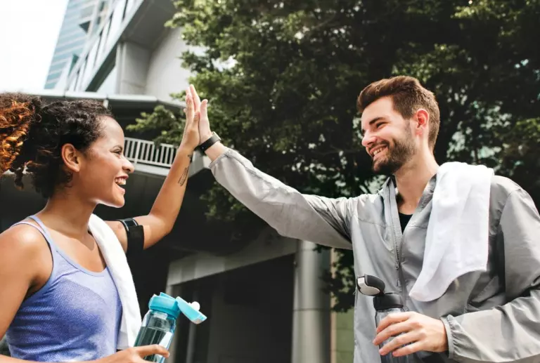 employees high-fiving after a workout